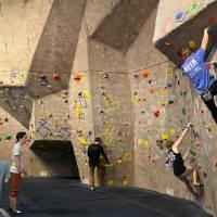 competitors climbing along the wall